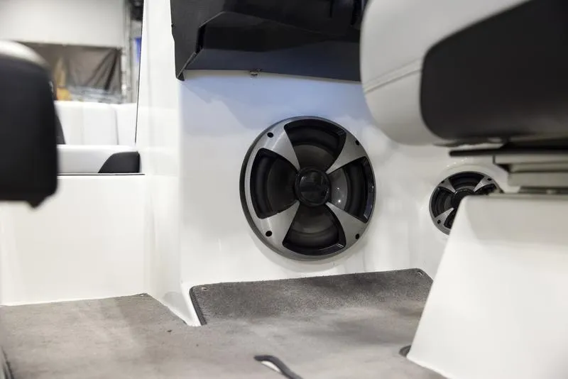 Slide: The Image of 2021 Malibu 21 MLX boat interior with built-in speaker system. - 12