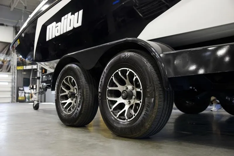 Slide: The Image of 2021 Malibu 21 MLX boat trailer with dual wheels in a garage setting. - 4