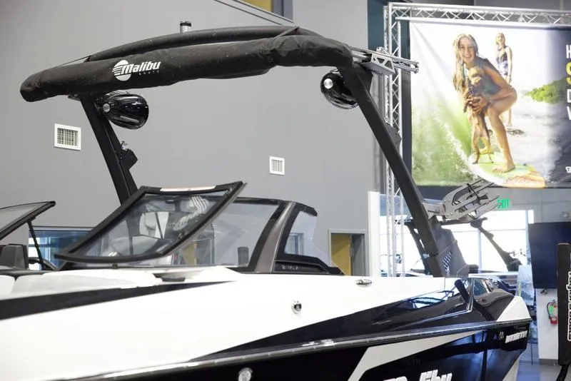 Slide: The Image of 2021 Malibu 21 MLX boat displayed indoors, featuring sleek design and modern features. - 5