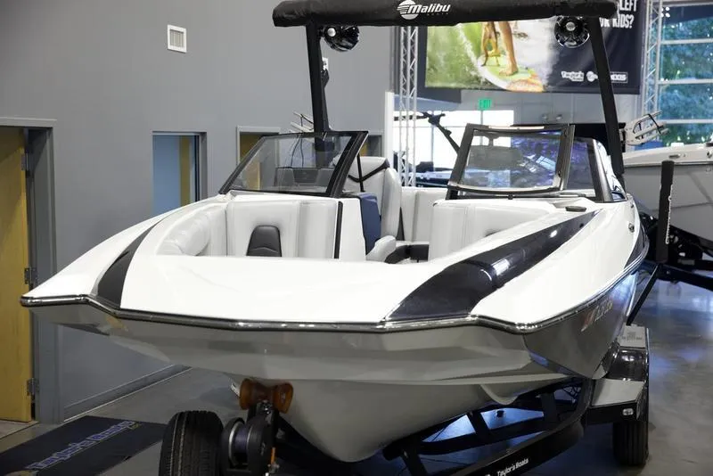 Slide: The Image of 2021 Malibu 21 MLX boat displayed indoors, featuring sleek design and modern features. - 6