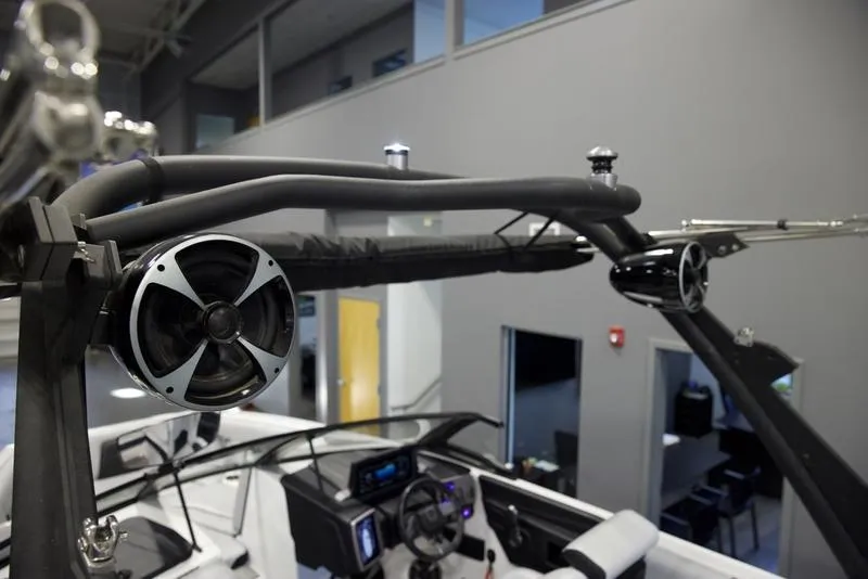 Slide: The Image of 2021 Malibu 21 MLX boat interior with speakers and steering wheel. - 8