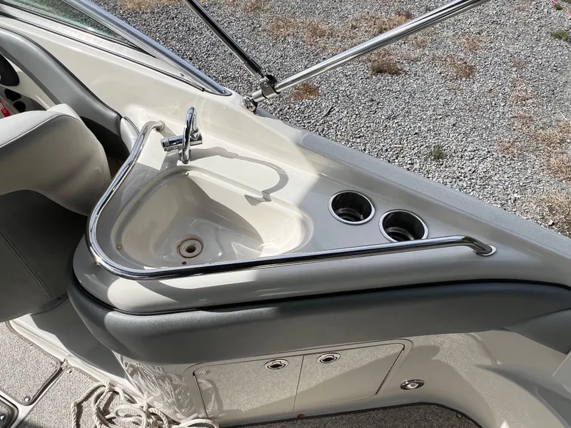 Slide: The Image of 2009 Sea Ray 240 Sundeck boat interior with sink and cup holders. - 12