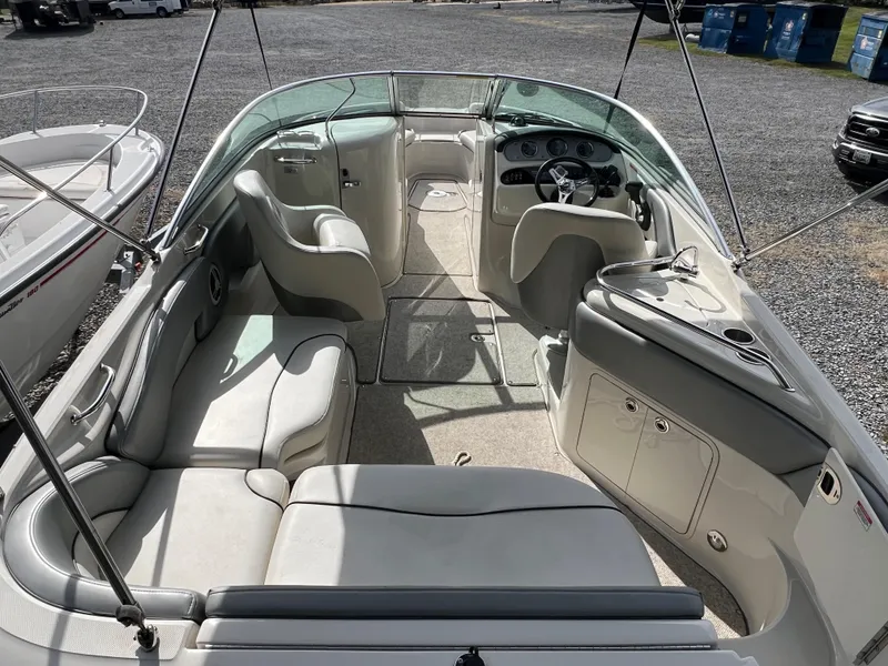 Slide: The Image of 2009 Sea Ray 240 Sundeck boat interior with spacious seating and modern dashboard. - 5