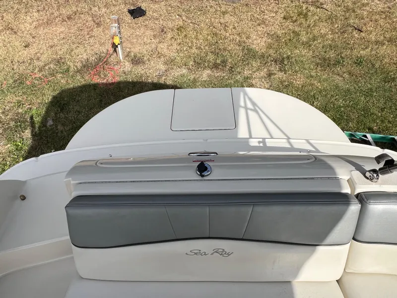 Slide: The Image of 2009 Sea Ray 240 Sundeck boat, rear seating area, on grass. - 6