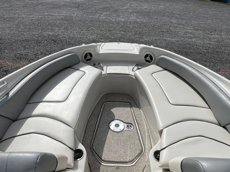 Slide: The Image of 2009 Sea Ray 240 Sundeck boat interior with cushioned seating and speakers. - 9