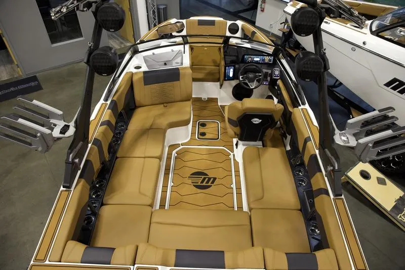 Slide: The Image of Luxurious interior of 2025 Malibu 22 MXZ boat with tan seating and modern dashboard. - 11