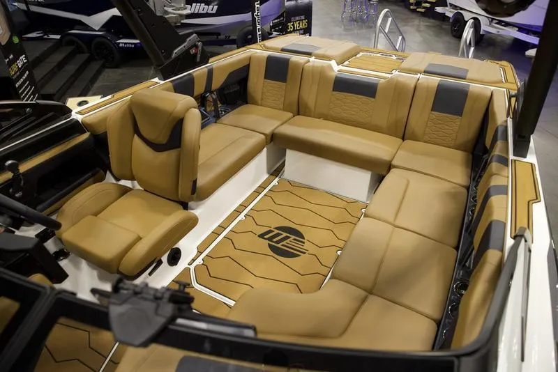 Slide: The Image of Luxurious interior of 2025 Malibu 22 MXZ boat with tan seating. - 21