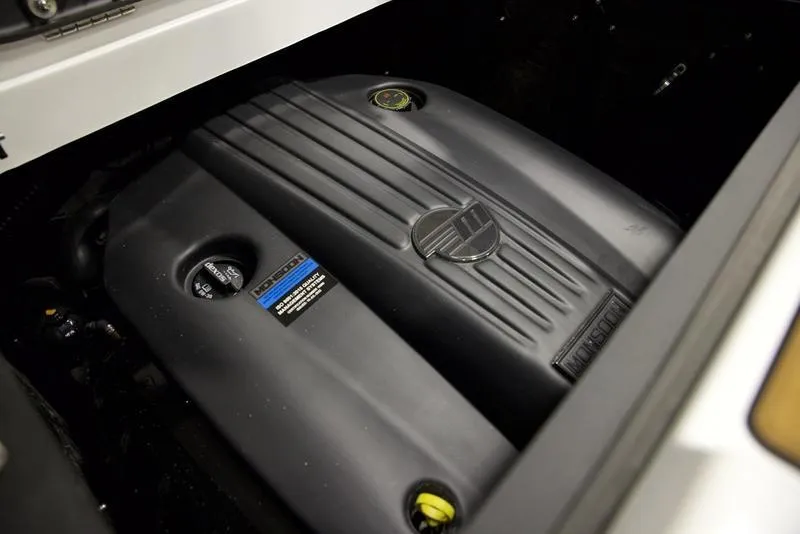 Slide: The Image of 2025 Malibu 22 MXZ engine compartment, showcasing sleek black engine cover. - 3