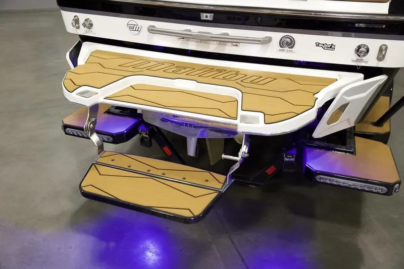 Slide: The Image of 2025 Malibu 22 MXZ boat platform with illuminated step and sleek design. - 6