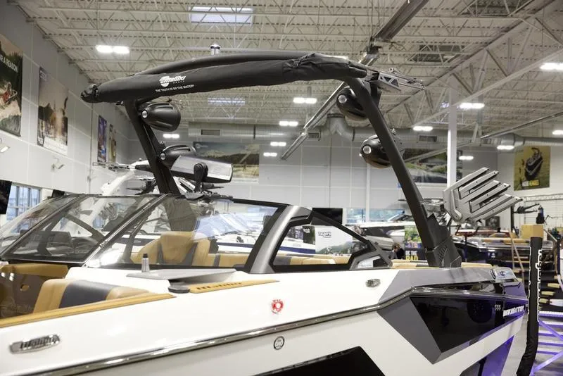 Slide: The Image of 2025 Malibu 22 MXZ boat in showroom, featuring sleek design and modern equipment. - 8