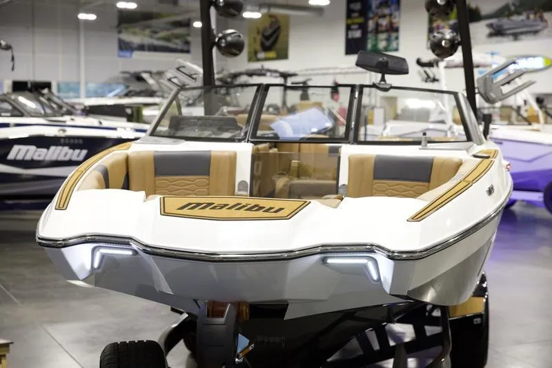 Slide: The Image of 2025 Malibu 22 MXZ boat displayed in a showroom, featuring sleek design and modern interiors. - 9