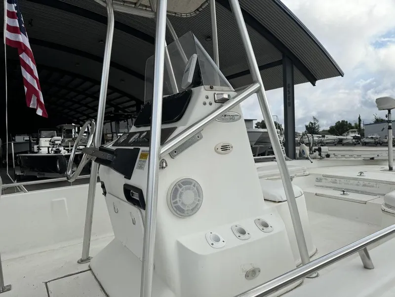 Slide: The Image of 2001 Bay Stealth VIP 2230 boat console with steering wheel and American flag. - 4