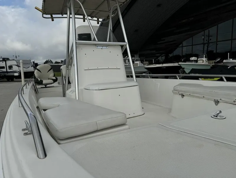 Slide: The Image of 2001 Bay Stealth VIP 2230 boat interior with seating and console, parked outdoors. - 9