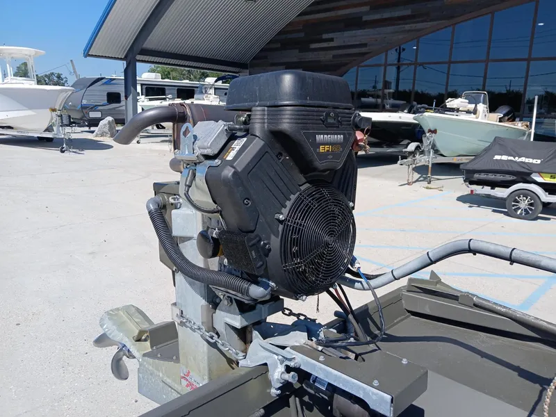 Slide: The Image of 2023 Go-Devil 18x48 boat engine, Vanguard EFI, in a marina setting. - 4