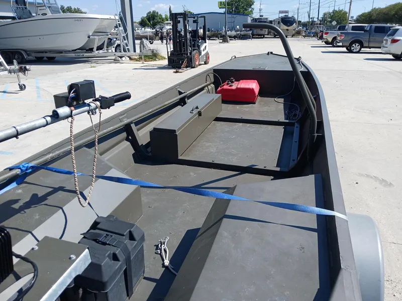 Slide: The Image of 2023 Go-Devil 18x48 boat with open deck and storage, parked outdoors. - 8