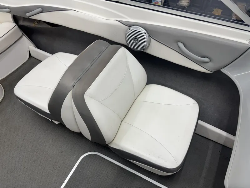 Slide: The Image of Interior seating of 2008 Bayliner Bowrider 185 boat, featuring white and gray upholstery. - 10
