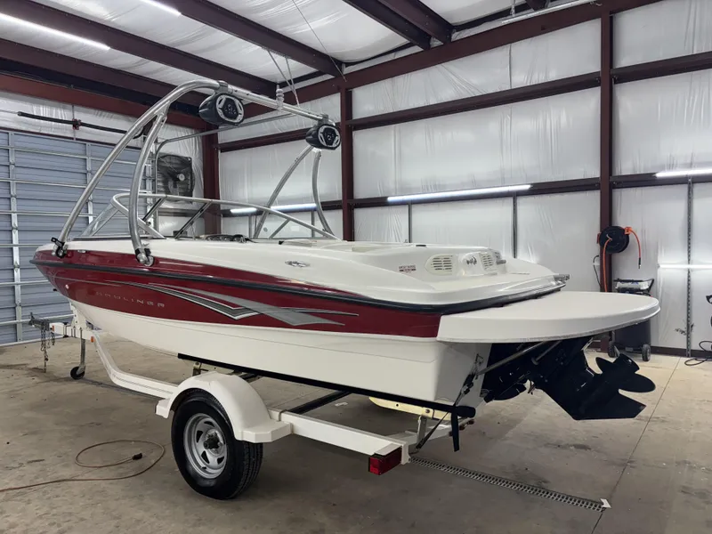 Slide: The Image of 2008 Bayliner Bowrider 185 in garage, red and white, on trailer. - 11
