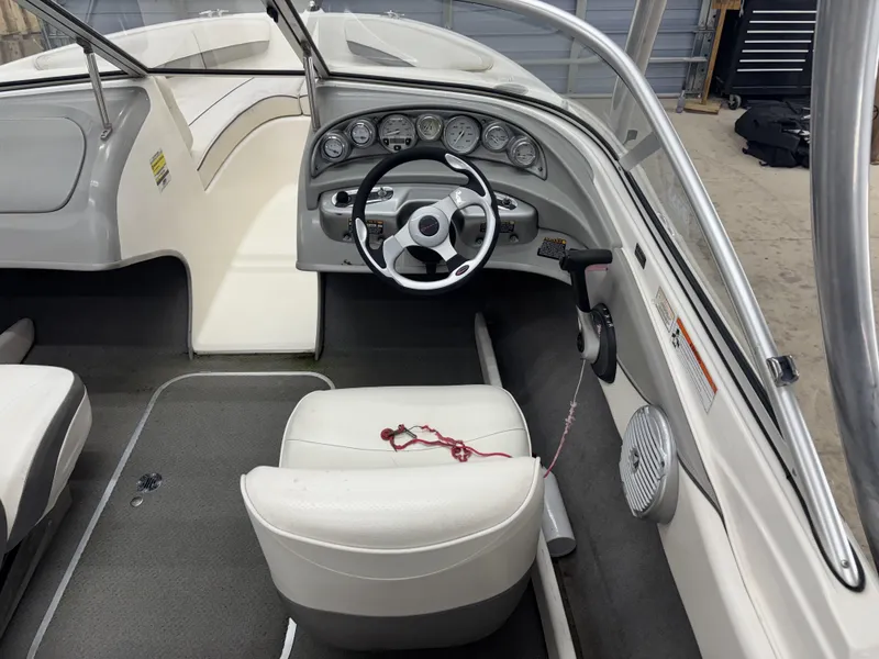 Slide: The Image of 2008 Bayliner Bowrider 185 interior with steering wheel and dashboard controls. - 15