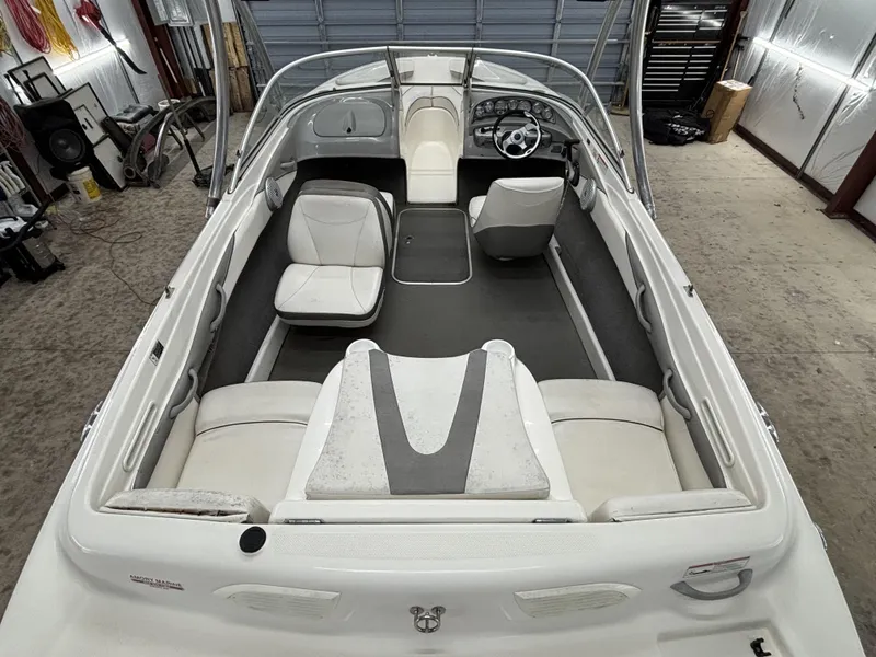 Slide: The Image of 2008 Bayliner Bowrider 185 interior, featuring white seating and steering wheel in a garage setting. - 4