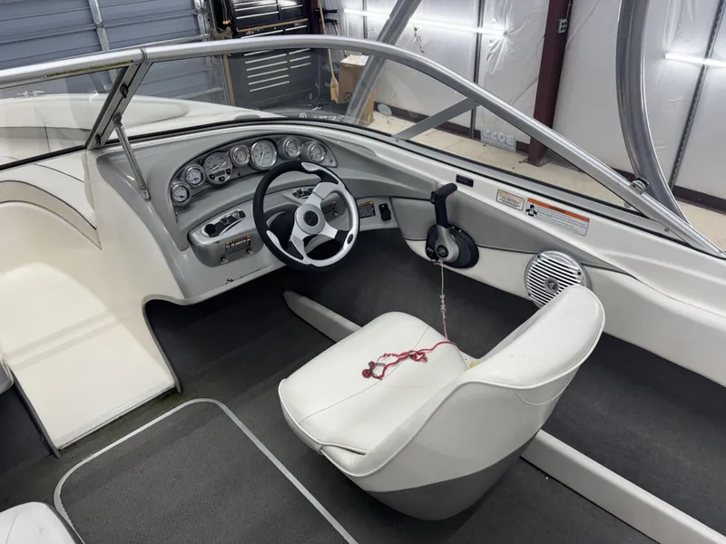 Slide: The Image of 2008 Bayliner Bowrider 185 interior with steering wheel and dashboard controls. - 6