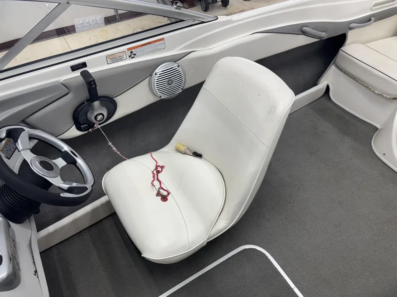 Slide: The Image of 2008 Bayliner Bowrider 185 interior with steering wheel and white seating. - 9