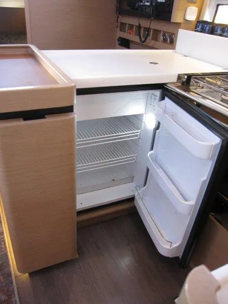 Slide: The Image of Interior of 2021 Jeanneau Sun Odyssey 440 with open fridge in galley. - 12