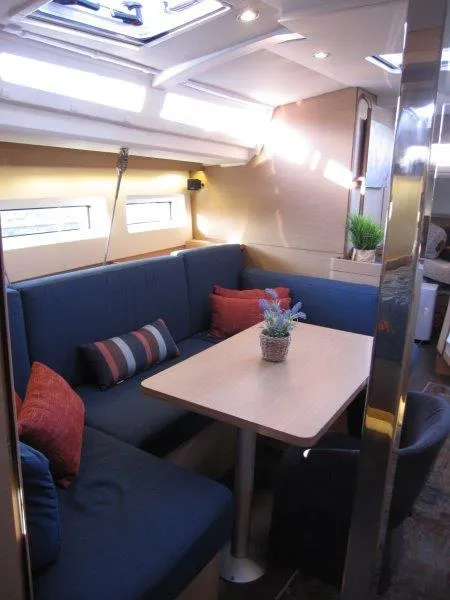 Slide: The Image of Interior of 2021 Jeanneau Sun Odyssey 440 with cozy seating and dining area. - 16