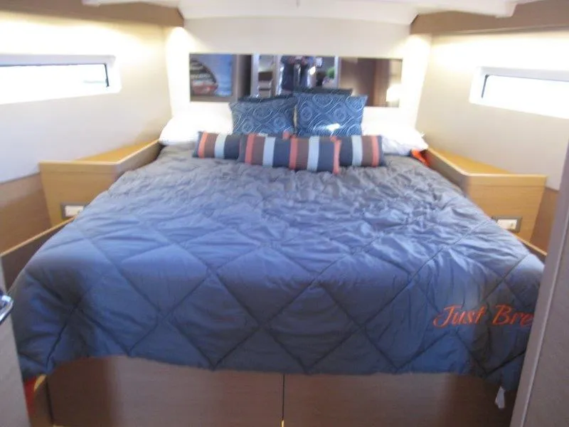 Slide: The Image of Cozy bedroom in 2021 Jeanneau Sun Odyssey 440 yacht with plush bedding. - 17