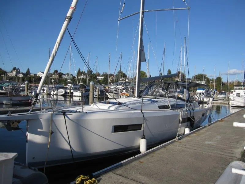 Slide: The Image of 2021 Jeanneau Sun Odyssey 440 sailboat docked at marina under clear blue sky. - 33