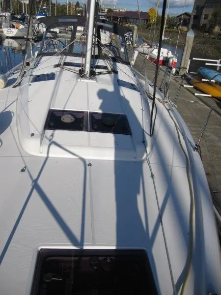 Slide: The Image of 2021 Jeanneau Sun Odyssey 440 sailboat docked at marina, shadow on deck. - 39