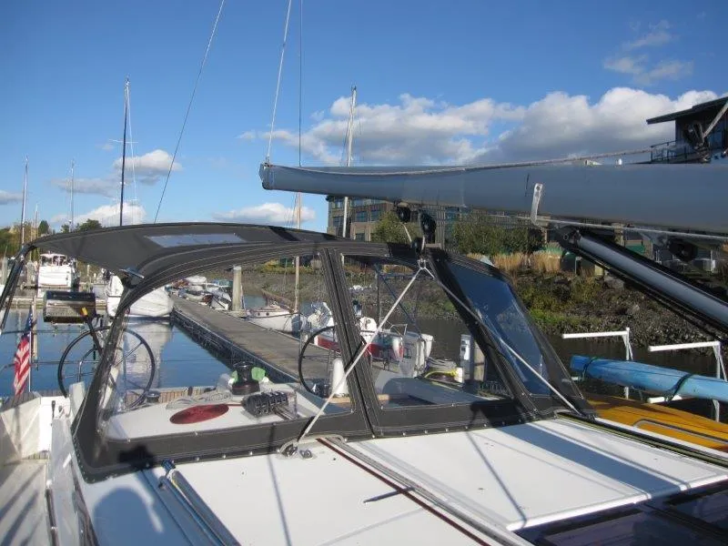 Slide: The Image of 2021 Jeanneau Sun Odyssey 440 sailboat docked in marina under clear blue sky. - 40