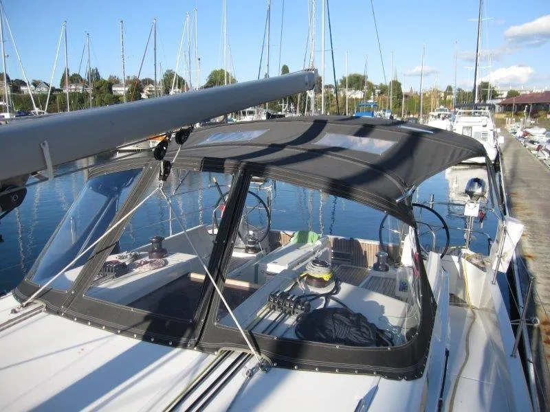 Slide: The Image of 2021 Jeanneau Sun Odyssey 440 sailboat docked in marina, featuring sleek design and spacious cockpit. - 42