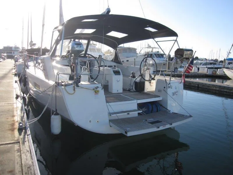 Slide: The Image of 2021 Jeanneau Sun Odyssey 440 sailboat docked at marina, rear view. - 44