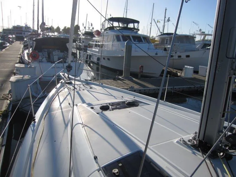 Slide: The Image of 2021 Jeanneau Sun Odyssey 440 sailboat docked at marina, surrounded by other boats. - 45