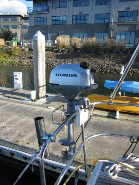 Slide: The Image of Honda outboard motor on Jeanneau Sun Odyssey 440, docked at marina. - 47