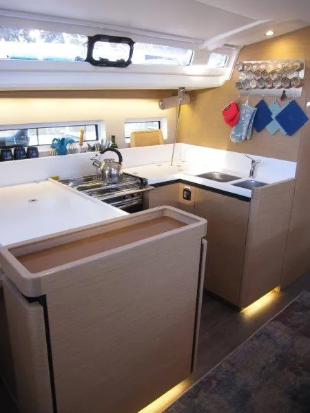 Slide: The Image of Modern kitchen in 2021 Jeanneau Sun Odyssey 440 yacht, featuring sleek design and ample storage. - 8