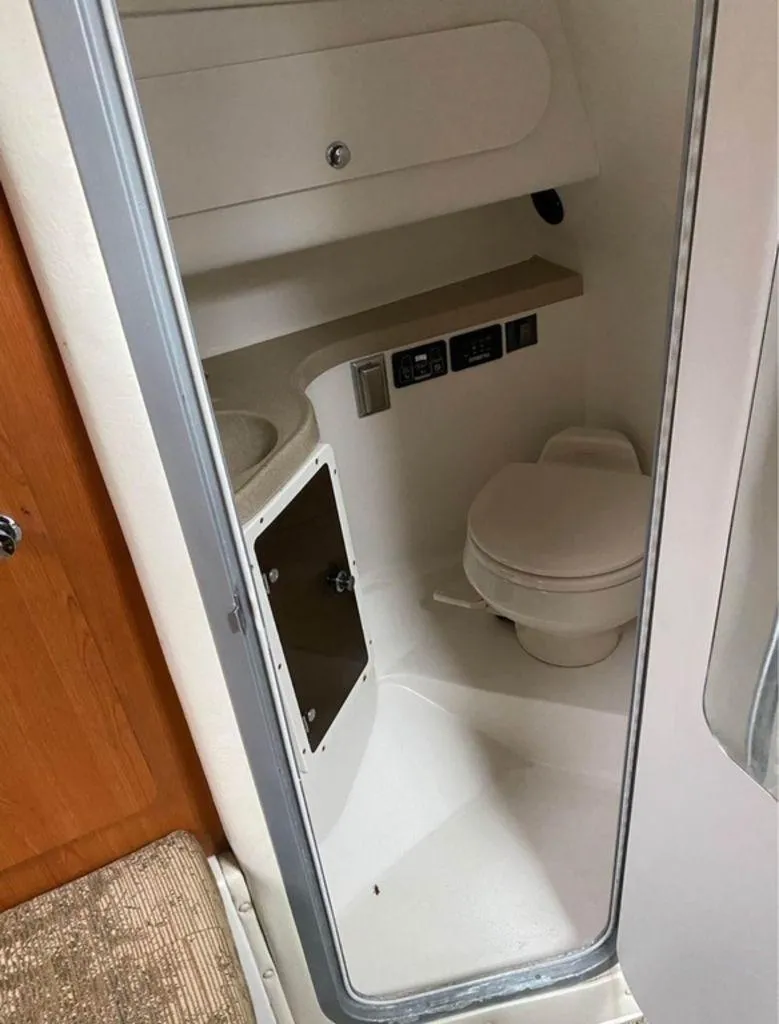 Slide: The Image of 2006 Seaswirl 2901 boat bathroom interior with toilet and storage. - 11