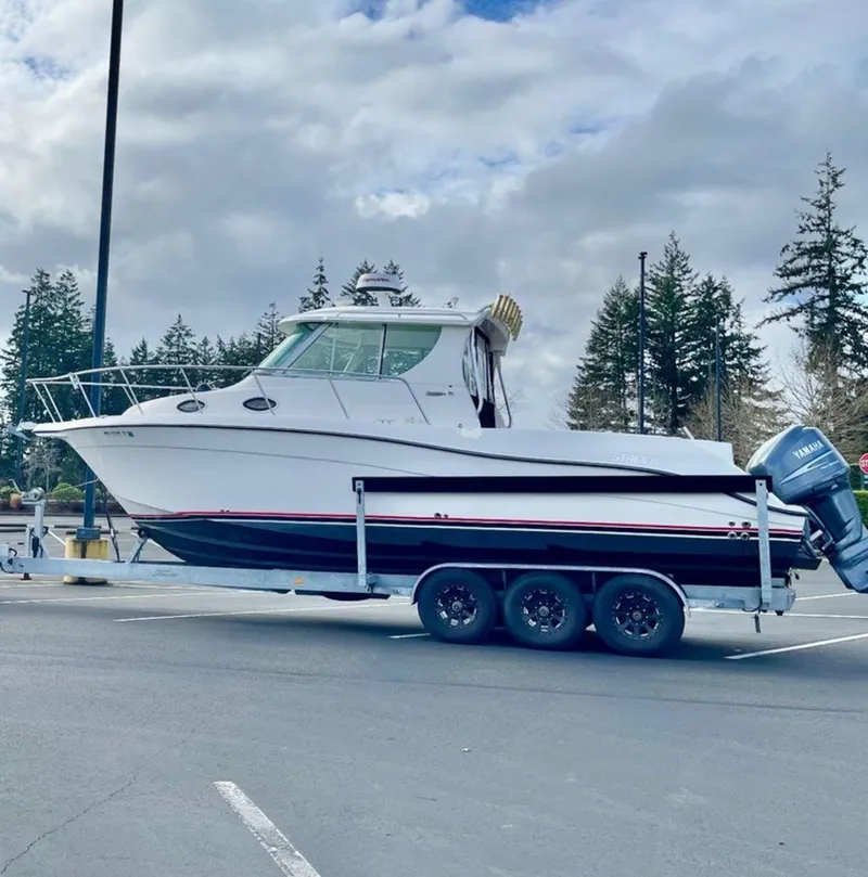 Slide: The Image of 2006 Seaswirl 2901 boat on trailer in parking lot, cloudy sky background. - 2