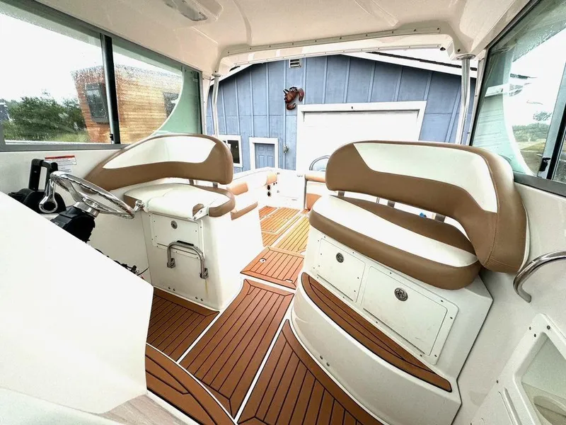 Slide: The Image of Interior of 2006 Seaswirl 2901 boat with tan seating and wood flooring. - 4
