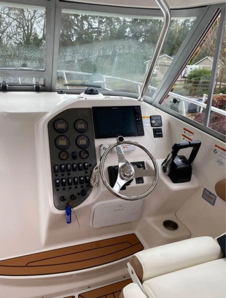 Slide: The Image of 2006 Seaswirl 2901 boat helm with steering wheel and control panel. - 8