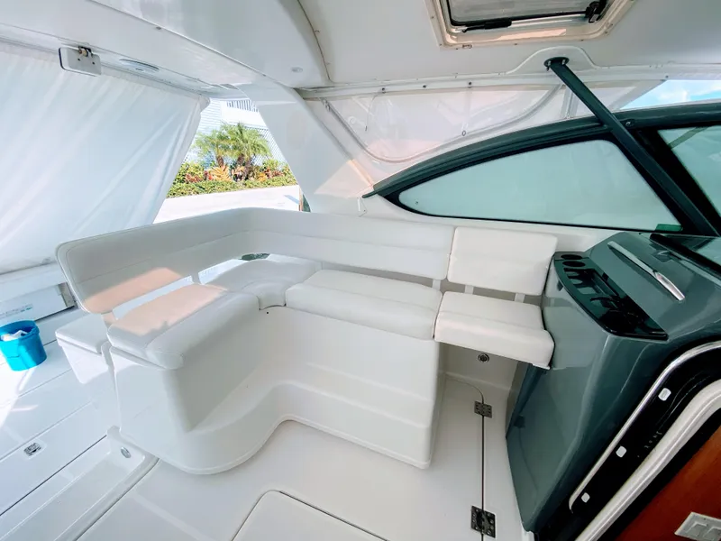 Slide: The Image of 2001 Tiara Yachts 3800 Open interior with white seating and sleek design. - 17