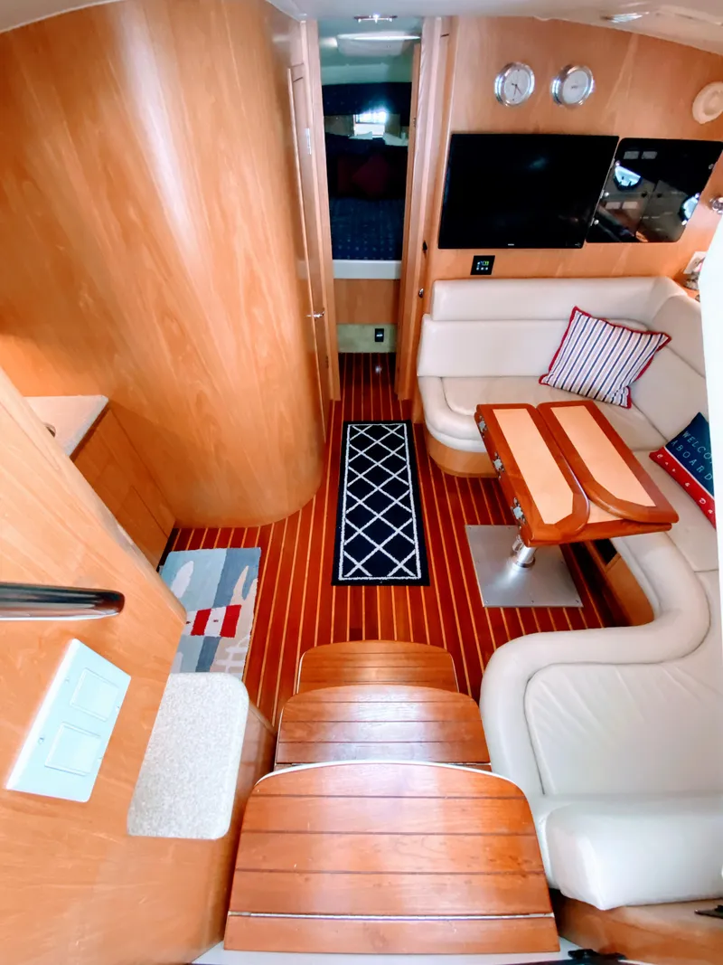 Slide: The Image of Interior of 2001 Tiara Yachts 3800 Open with wood finish and cozy seating area. - 28