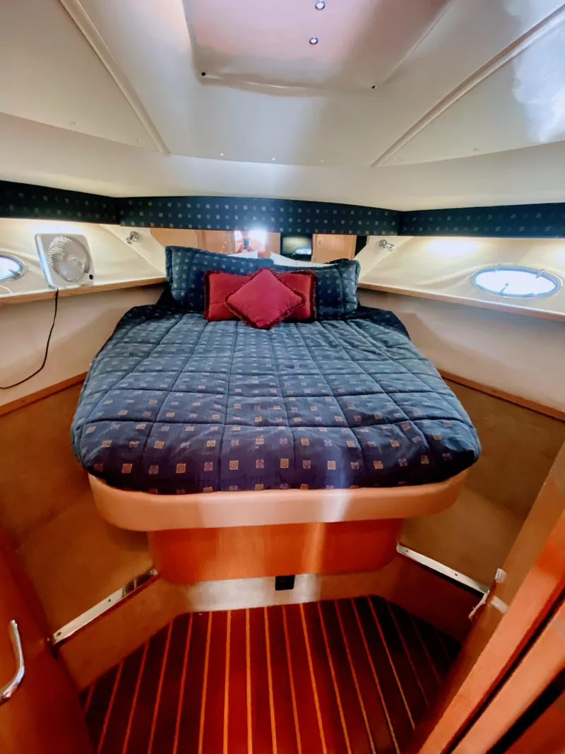 Slide: The Image of Luxurious cabin interior of 2001 Tiara Yachts 3800 Open with cozy bedding. - 38