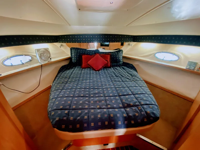 Slide: The Image of 2001 Tiara Yachts 3800 Open cabin with cozy bed and porthole windows. - 39