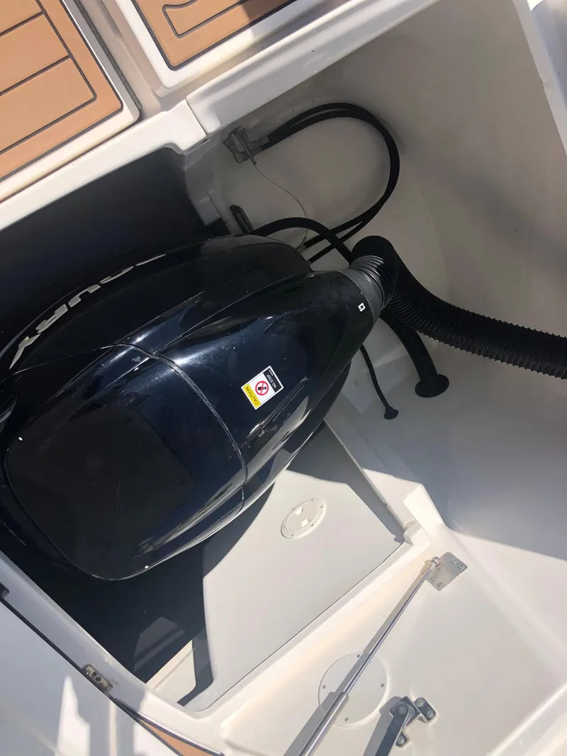 Slide: The Image of 2014 Sea Ray 370 Venture engine compartment with black engine cover. - 17