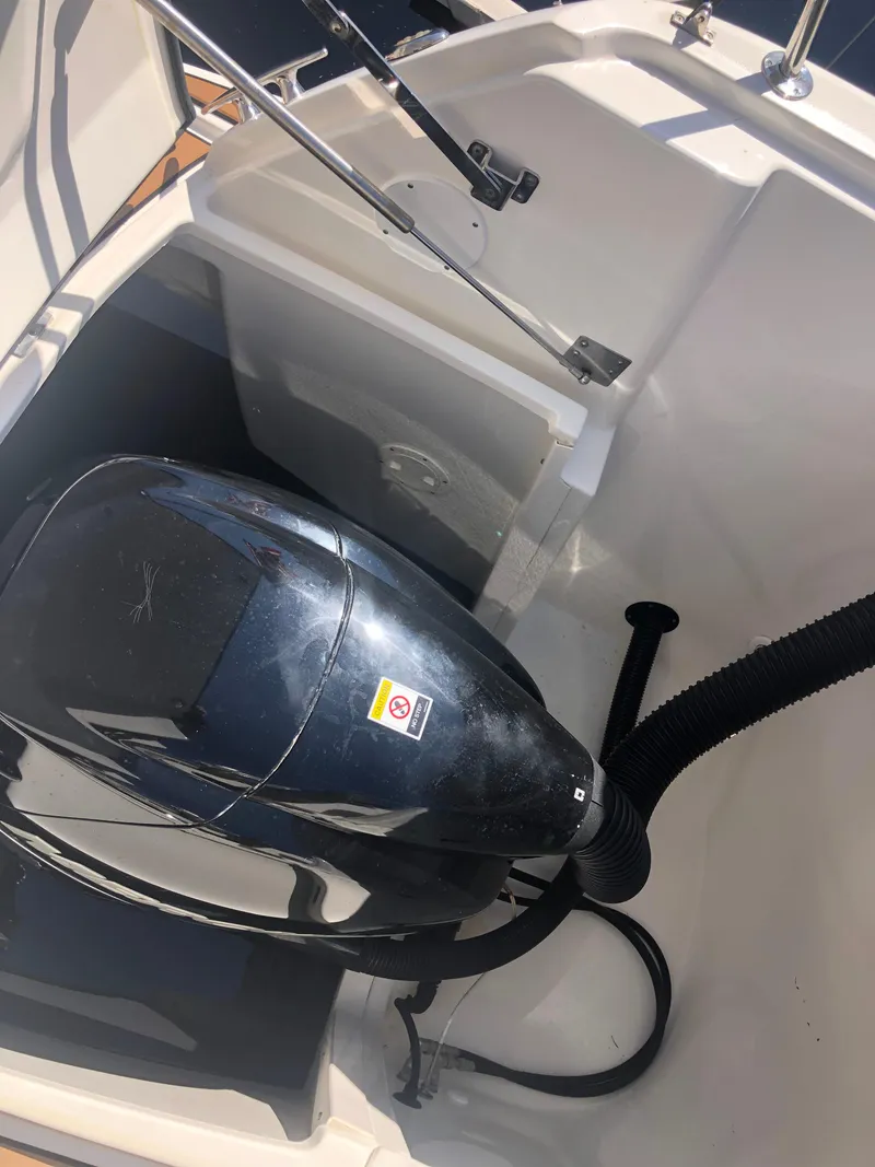 Slide: The Image of 2014 Sea Ray 370 Venture engine compartment with visible outboard motor. - 18