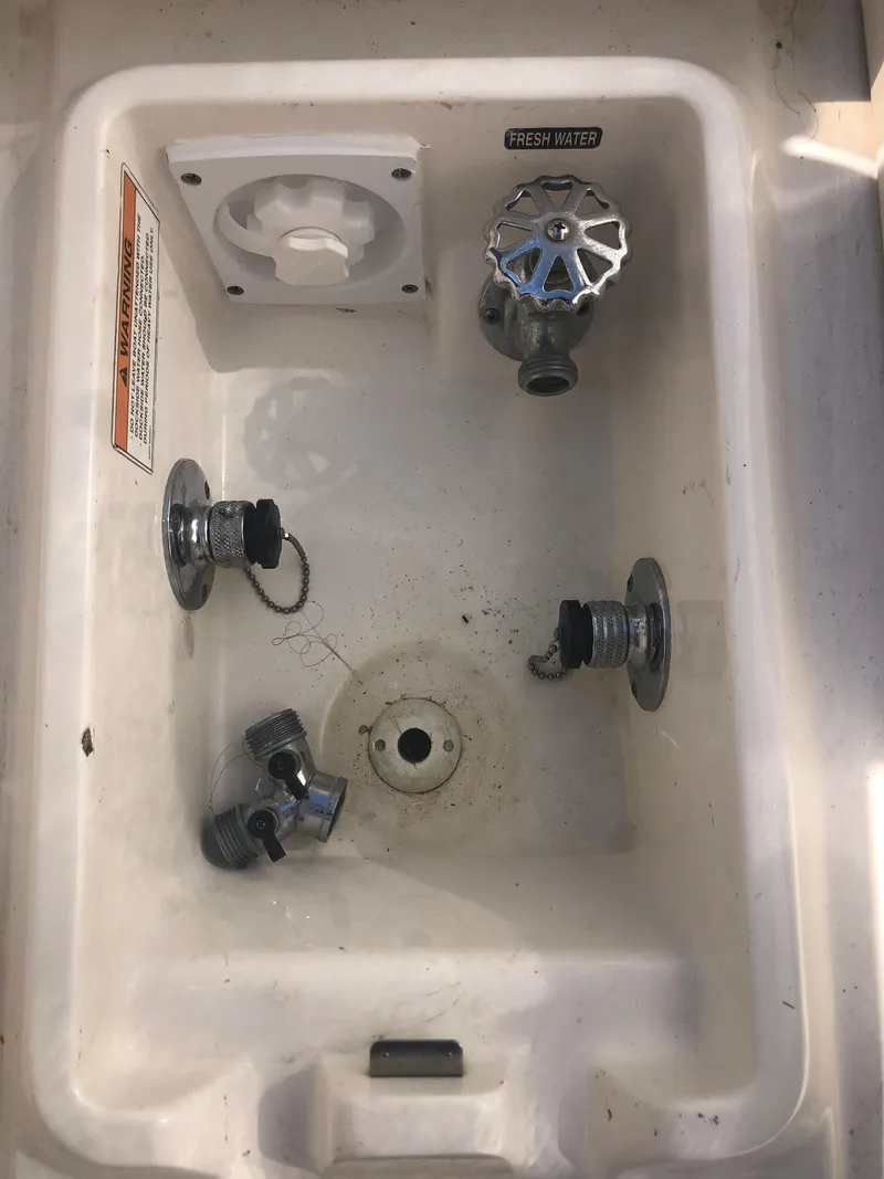 Slide: The Image of 2014 Sea Ray 370 Venture boat plumbing compartment with valves and fittings. - 19