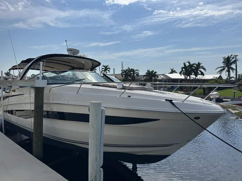 Slide: The Image of 2014 Sea Ray 370 Venture yacht docked in sunny marina. - 2