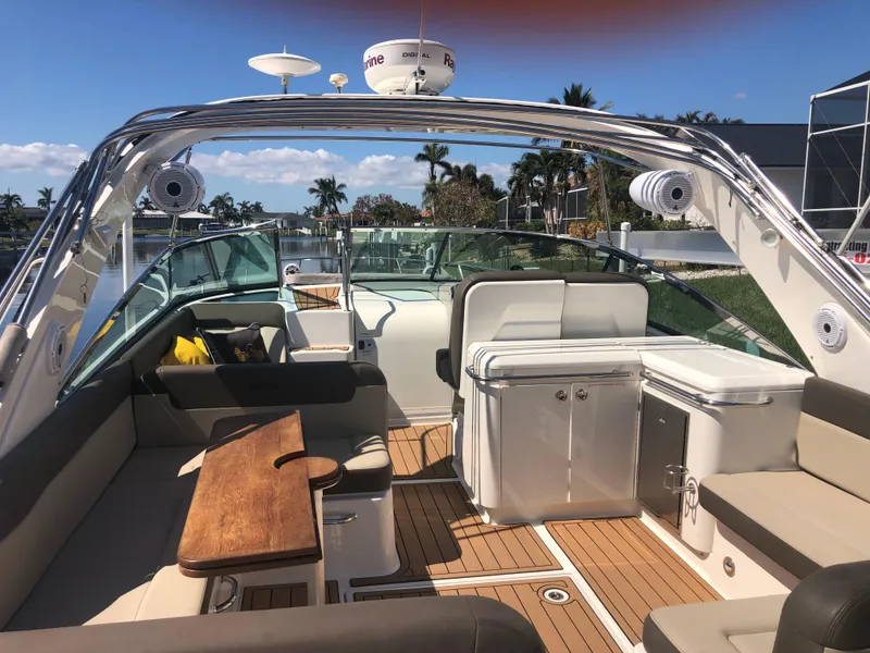 Slide: The Image of 2014 Sea Ray 370 Venture boat interior with seating and wooden table. - 20