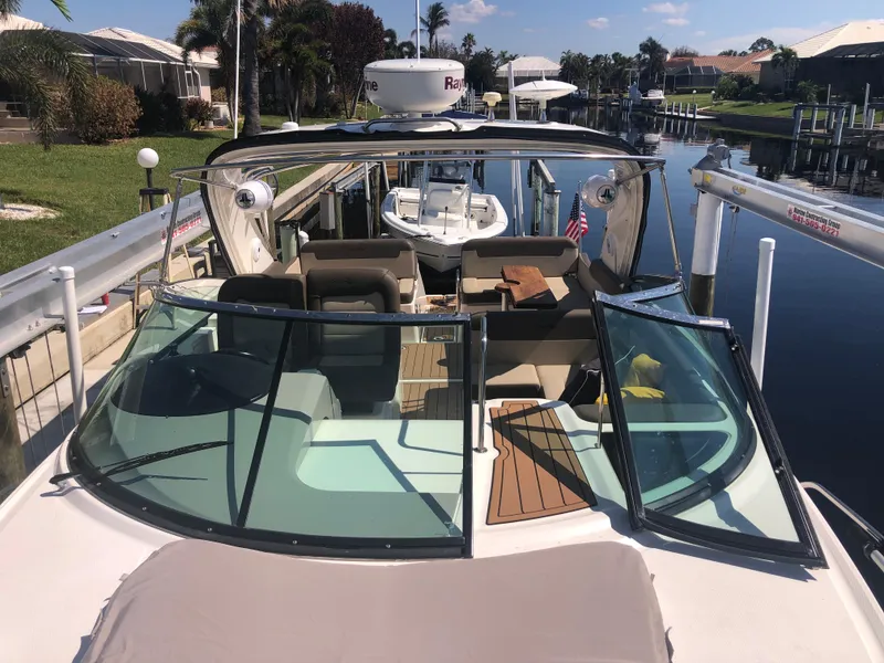 Slide: The Image of 2014 Sea Ray 370 Venture boat docked in a sunny canal setting. - 21